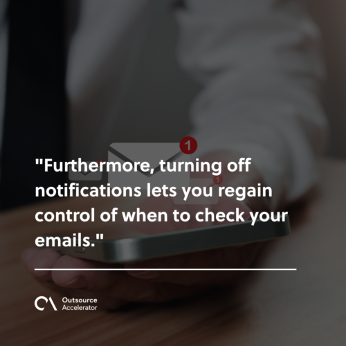 businessman holding a phone along with the e-mail icon