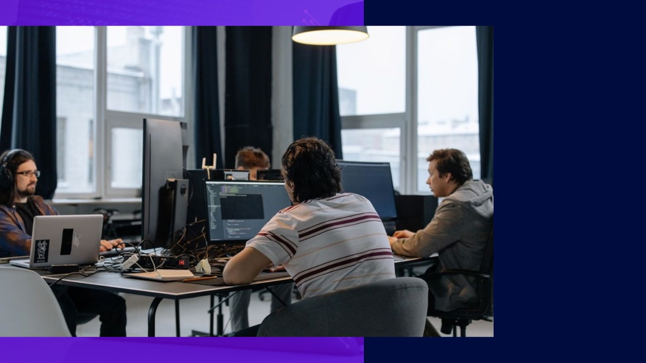 Developers working at computers, highlighting top tech recruiting agencies.
