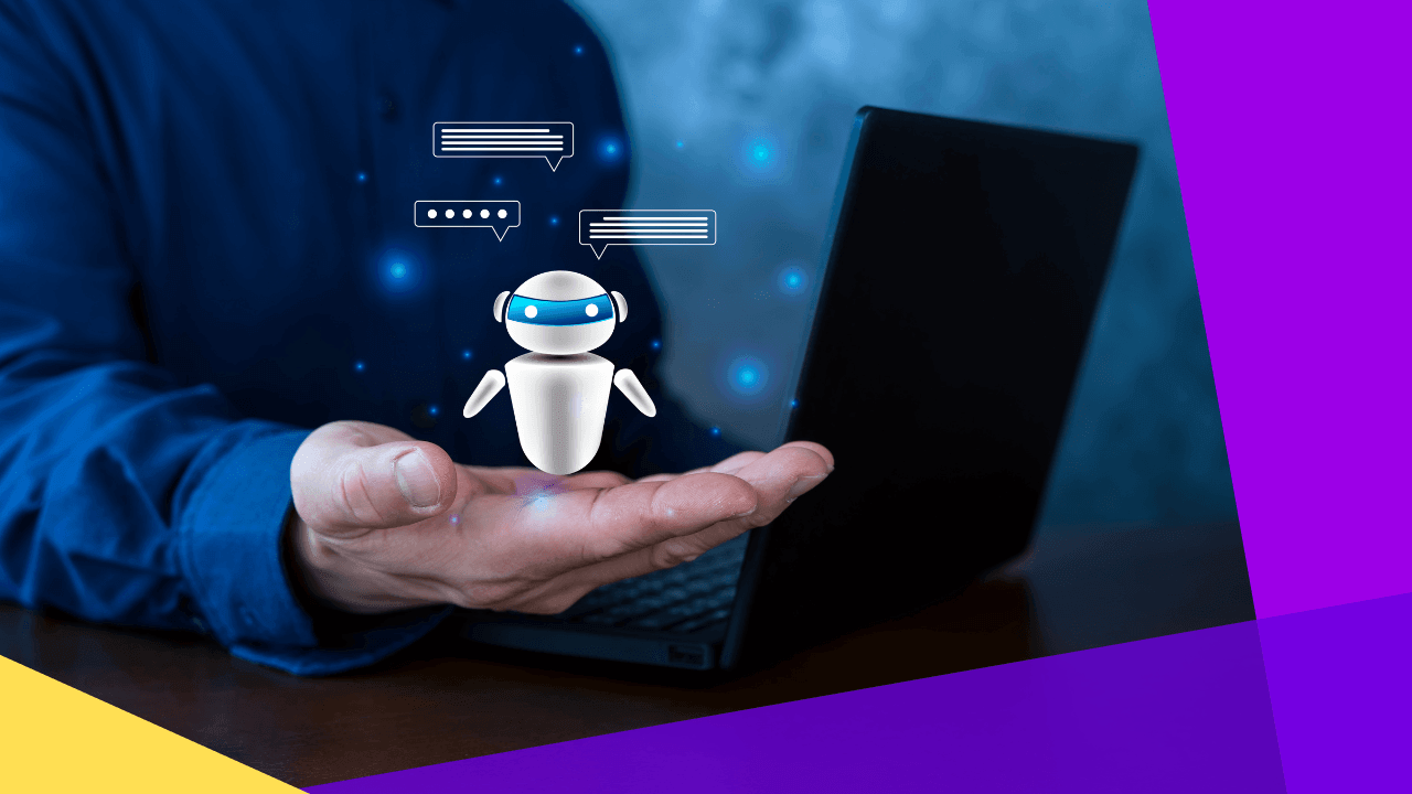 Man in a blue shirt holding out his palm under a small floating robot with chat bubbles beside a laptop, dark backdrop.