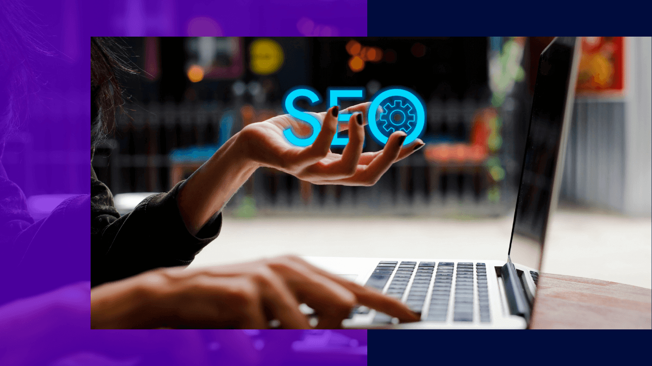 Hand gesturing under a glowing blue SEO sign with a gear icon while the other hand types on a laptop, blurred café behind.