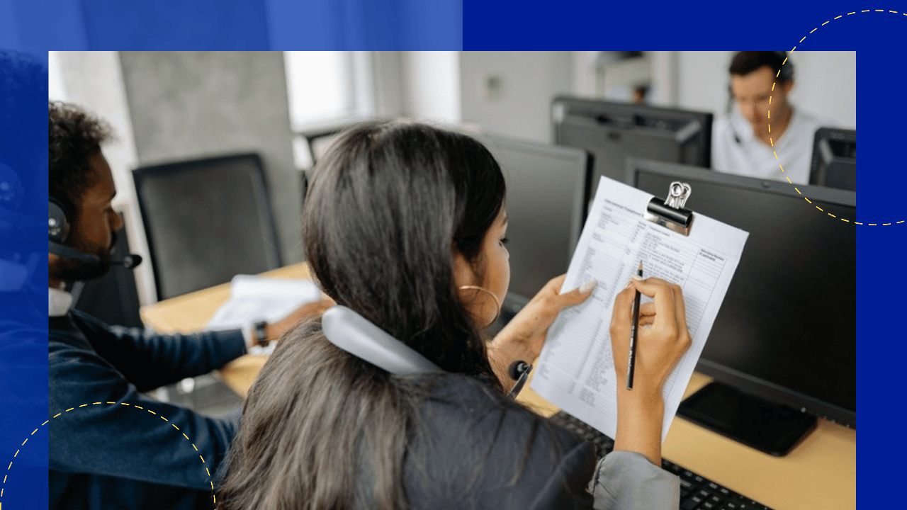 Insurance back office outsourcing - agent on a headset processing a paper form at a computer