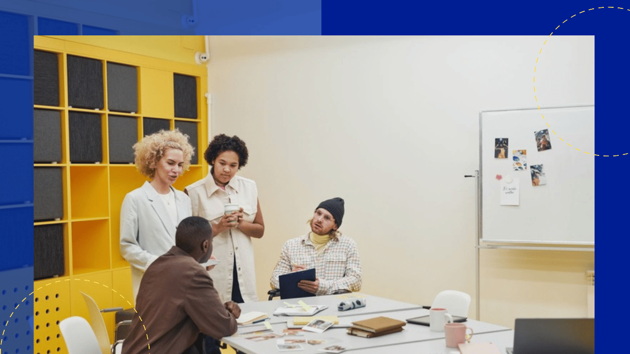 co-managed offshore team compliance - team meeting around a table in a modern office