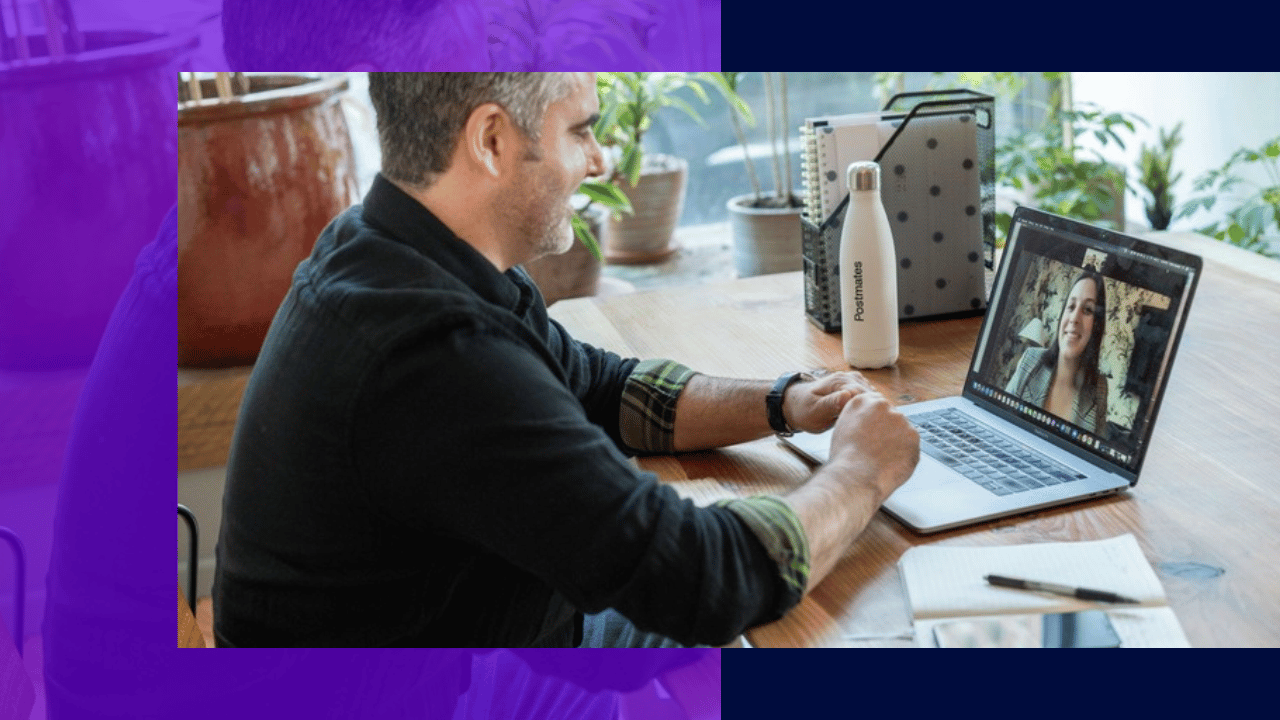 remote employee communication - man on a video call with a remote colleague at his home desk